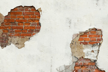 Old red brick wall with white stucco, paint and cracks.