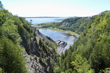 Fototapeta na wymiar Montmorency Fall is a waterfall in the Canadian province of Quebec, which forms the mouth of the Montmorency River and plunges into the St. Lawrence River.