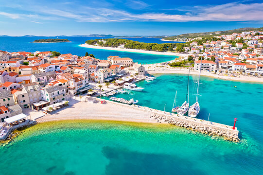 Adriatic tourist town of Primosten turquoise beach and seafront aerial view