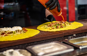 process of preparing traditional Turkish fast food - grilled meat or shawarma or kebab. chef hand cooking food