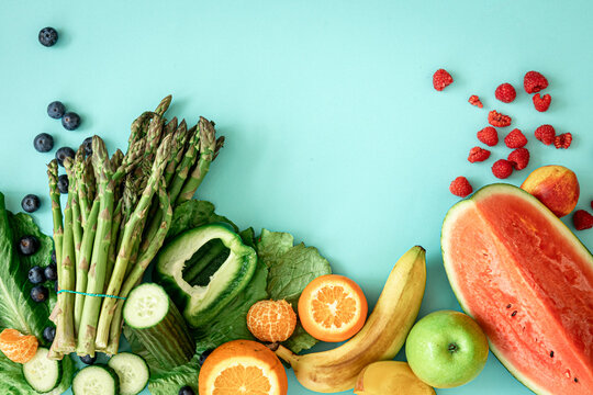 Fruits, berries and vegetables on a blue background.
