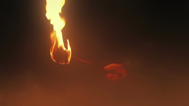Torch Held Up And Goes Off In The Mist