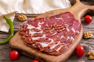Turkish pastrami. Bacon made from ribeye meat. Beef pastrami sliced Pastirma or Turkish pastrami. Close-up.