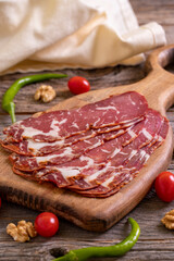 Turkish pastrami. Bacon made from ribeye meat. Beef pastrami sliced Pastirma or Turkish pastrami. Close-up.