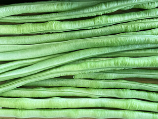 Texture image of yard long bean on wooden table.