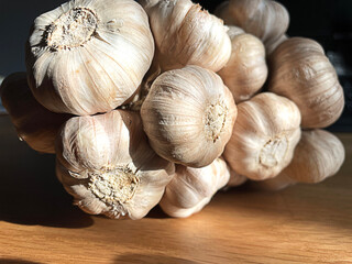 Closeup group of garlic on wooden table.