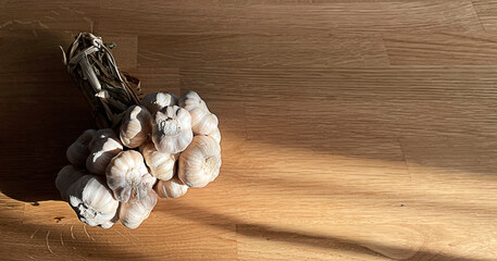 Closeup group of garlic on wooden table with copy space