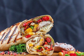 Turkish cuisine chicken wrap. Grilled chicken sandwich wrap with lettuce, red pepper and french...