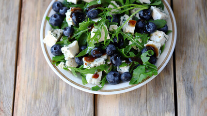 Delicious salad with blueberries and arugula. Fresh menu. Beautiful food. salad trend.