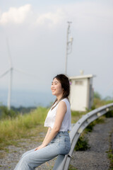 cute girl standing and playing with beautiful nature with clear sky on vacation They stood and took pictures happily.