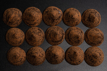 Chocolate truffles on a black background.