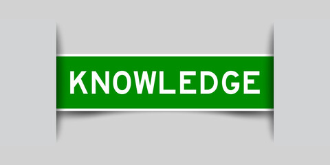Inserted green color label sticker with word knowledge on gray background