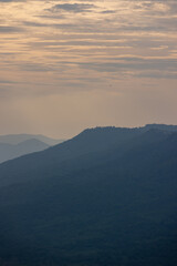 Beautiful nature, verdant trees with bright sky. and a tall white windmill Producing electricity in Thailand