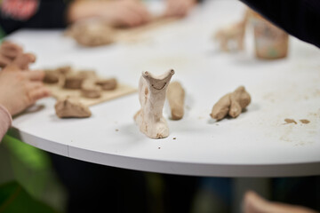 various clay figurines on a shelf, at a creative master class for children 