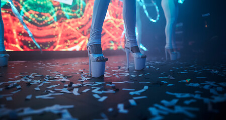 PJ girl dancing on stage in white high-heeled sandals 