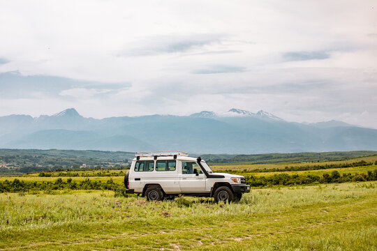 Profile of Toyota Land Cruiser HZJ78 Hardtop parked on field in front of Accursed Mountain Range in Gjakov&euml;, Kosovo