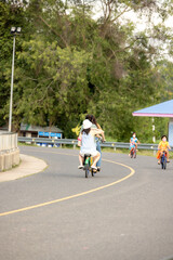 people riding bicycles, playing and exercising on vacation On the road and see the beautiful nature Thailand Dates 28-5-2022