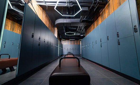 Empty modern dark gym locker room. Stylish indoor fitness club locker room.