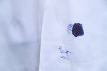 Dirty blue ink stain on bag shirt  from using pen in daily life activity. dirty stains for cleaning...