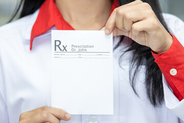 Asian female medicine doctor hand hold clipboard pad and give prescription to patient closeup....