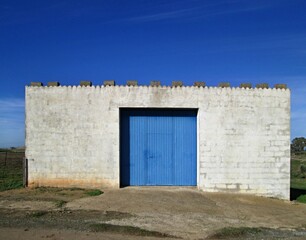 Fototapeta na wymiar Blue garage door and blue sky 