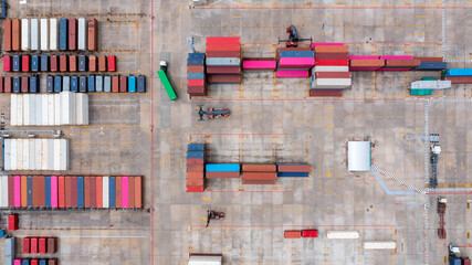 Aerial view of loading and moving containers on container yard, Container terminal international containers cargo ship industrial import export port global transportation and logistic business.