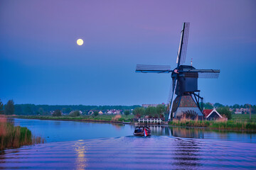 Netherlands rural landscape with windmills at famous tourist site Kinderdijk in Holland in twilight...