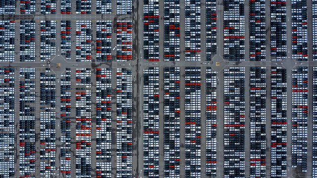 Aerial top view cars for sale stock lot row. Car dealer inventory, Car lined up at port for import export business logistic to dealership for sale, Automobile and automotive car parking lot commercial
