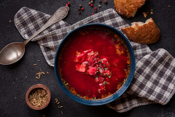Red beetroot vegetable soup with bread, hot soup in a bowl