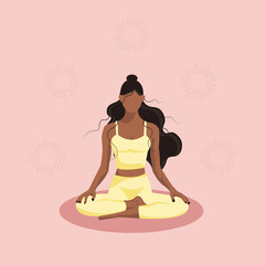 Black girl in the lotus position with an ornament
