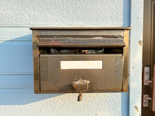 An old stainless steel mailbox