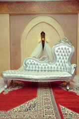 An elegantly staged traditional moroccan style wedding with large sofa for the wedding couple to...