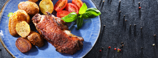 Pan-fried beef steak with fried potatoes and cherry tomatoes