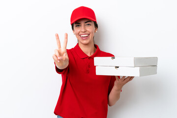 Pizza delivery caucasian woman with work uniform picking up pizza boxes isolated on white...