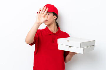 Pizza delivery caucasian woman with work uniform picking up pizza boxes isolated on white background making stop gesture and disappointed