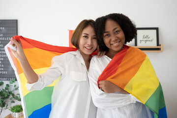 Diversity African American  Asian Married couples Lesbian LGBTQ.Engaged homosexual Hug together Rainbow flag.Sexual equality,LGBT Pride month,Parade celebrations concept.Family of happiness smiling.