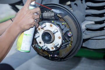 Maintenance and repair of cars in the service center. Close-up of the hands of a mechanic...