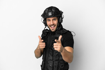 Young caucasian swat isolated on white background pointing to the front and smiling