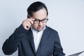 Asian Businessman holding tablet on hands. Portrait manager confident successful of business isolated on white background with copy space. Business, financial, and leadership.