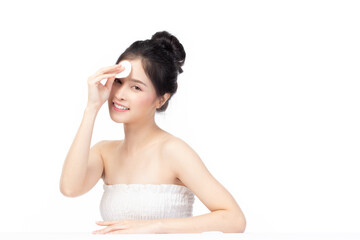 Obraz na płótnie Canvas Attractive beauty young asian woman clean skin with cotton pad removing make up on isolated white background.