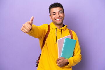 Young student Brazilian man isolated on purple background giving a thumbs up gesture