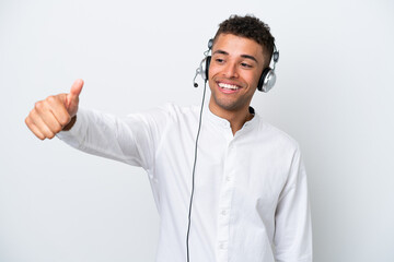 Telemarketer Brazilian man working with a headset isolated on white background giving a thumbs up gesture