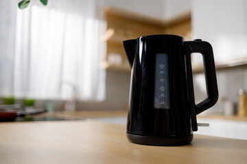 Modern black electric kettle on kitchen table