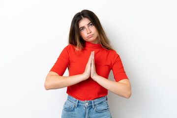 Young caucasian woman isolated on white background keeps palm together. Person asks for something