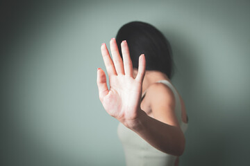 Closeup image of a woman outstretched hand and showing stop hand sign - Powered by Adobe