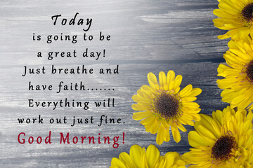 Motivational quote on wooden surface and sunflowers.