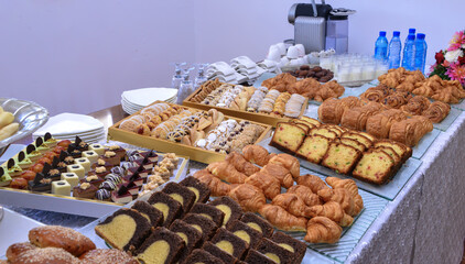 Moroccan pastries buffet, sweets, cake, croissants, dates and milk