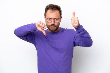 Fototapeta premium Middle age caucasian man isolated on white background making good-bad sign. Undecided between yes or not