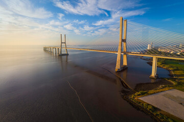 Vasco da Gama bridge over tagus river in Lisbon, Portugal, at sunrise, aerial (drone) view