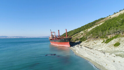Famous abandoned wreck on the sea. Shot. Top view of an abandoned ship on the beach
